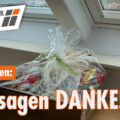 Bild mit einem Geschenkkorb vor einer neu eingebauten Lichtlösung. Text: Von Herzen: Wir sagen DANKE! Außerdem ist da Logo der DACHFENSTER-RETTER zu erkennen.